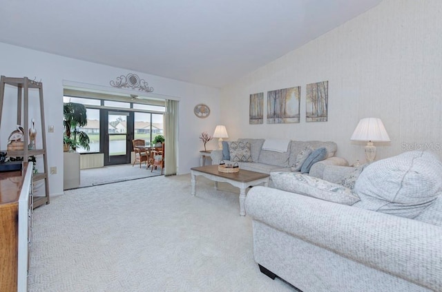 carpeted living room featuring lofted ceiling and radiator heating unit