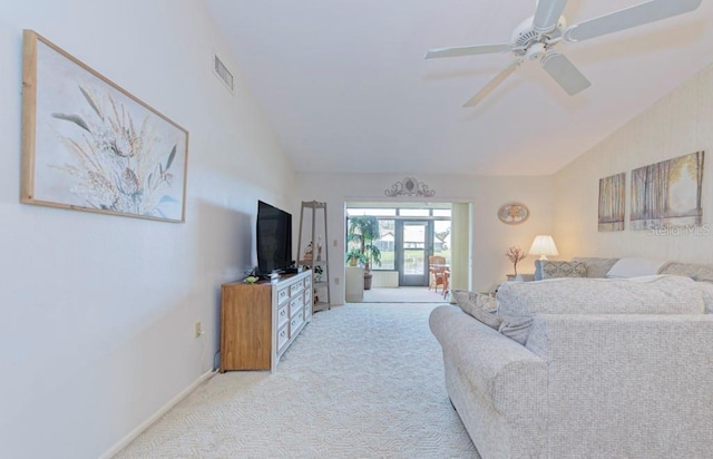 carpeted living room featuring ceiling fan, french doors, and lofted ceiling