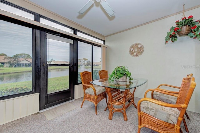 interior space featuring ceiling fan and a water view