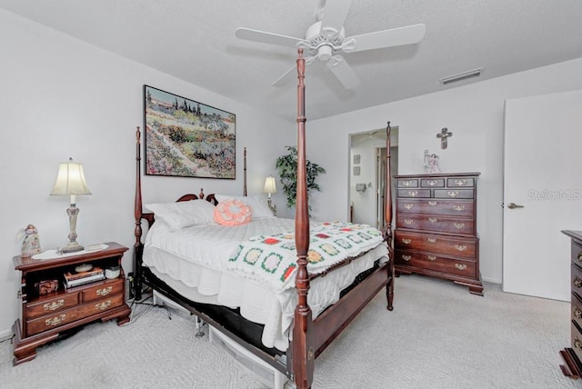 bedroom featuring light carpet and ceiling fan