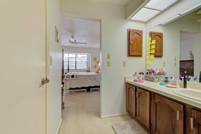 bathroom featuring ceiling fan and vanity