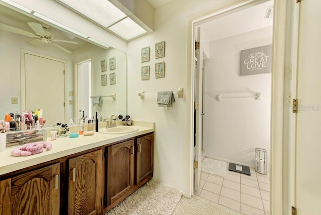 bathroom with tile patterned flooring, vanity, and ceiling fan