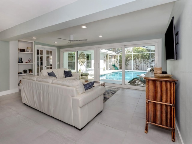 living area with a sunroom, ceiling fan, recessed lighting, and baseboards