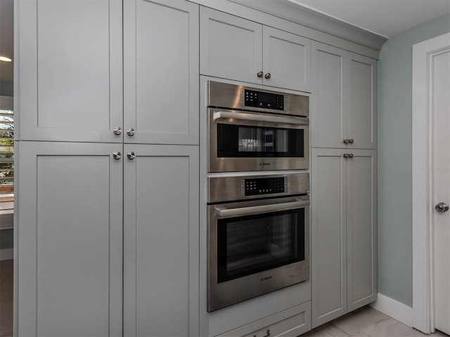 kitchen with double oven and baseboards