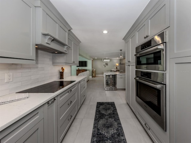 kitchen with gray cabinetry, black electric cooktop, tasteful backsplash, beverage cooler, and recessed lighting