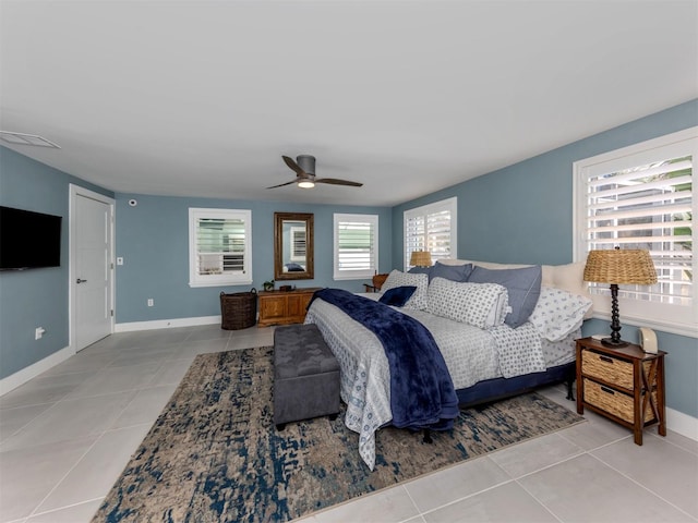 bedroom with light tile patterned floors, baseboards, and ceiling fan