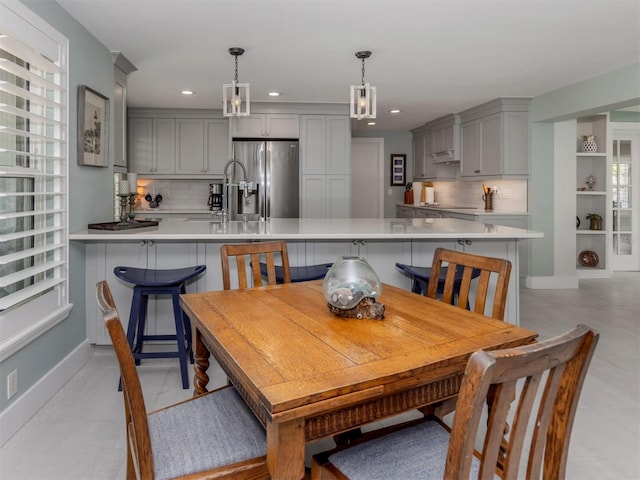 dining room with recessed lighting and baseboards