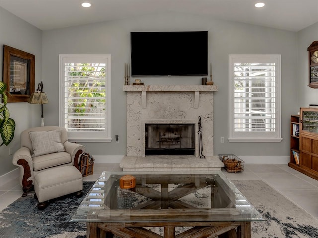 tiled living room featuring a fireplace, baseboards, healthy amount of natural light, recessed lighting, and vaulted ceiling