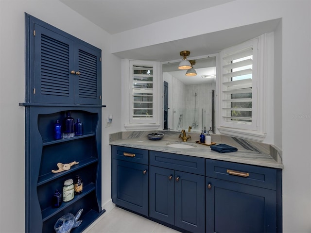 full bathroom with tiled shower and vanity