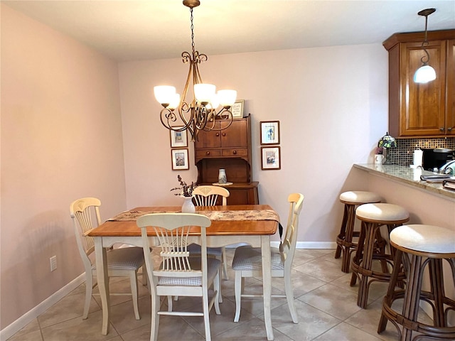 dining area featuring light tile patterned floors and a chandelier