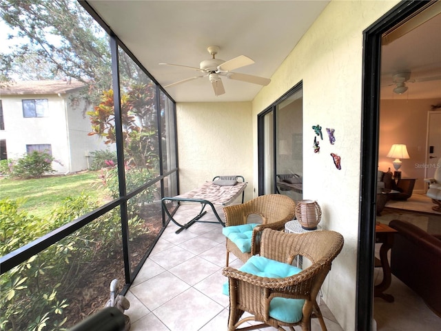 sunroom featuring ceiling fan