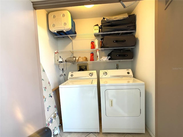 laundry area featuring washing machine and dryer and light tile patterned floors