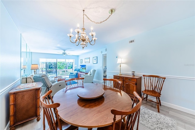 dining area featuring ceiling fan with notable chandelier and light hardwood / wood-style flooring