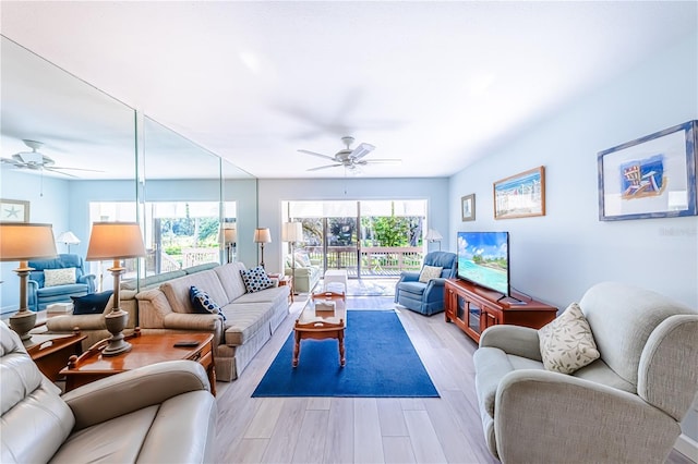 living room featuring ceiling fan and light hardwood / wood-style flooring