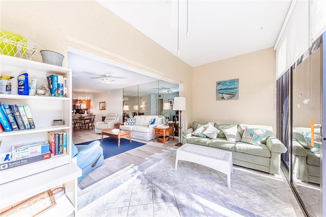 living room with built in features and ceiling fan