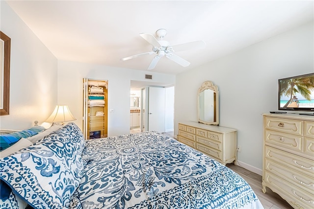 bedroom featuring ensuite bath and ceiling fan