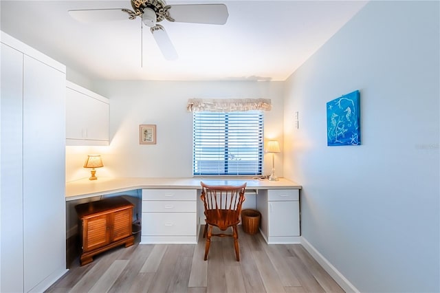 office with ceiling fan, light wood-type flooring, and built in desk