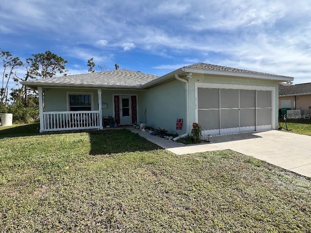 view of front of home with a garage, covered porch, and a front lawn