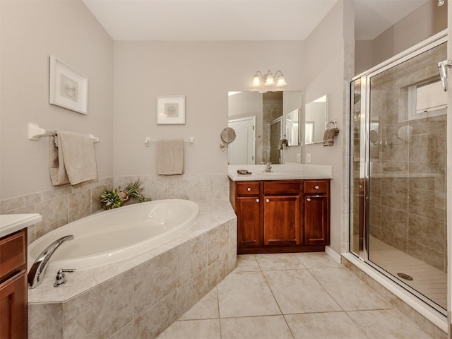 bathroom with vanity, tile patterned flooring, and plus walk in shower