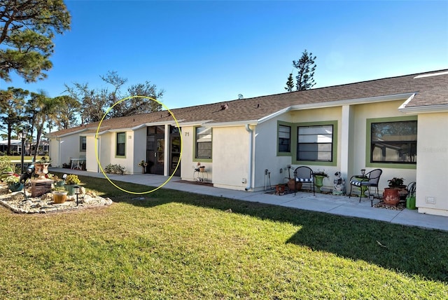 back of house with a yard and a patio area