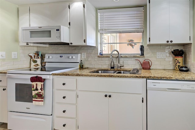 kitchen with white cabinetry, sink, white appliances, and decorative backsplash