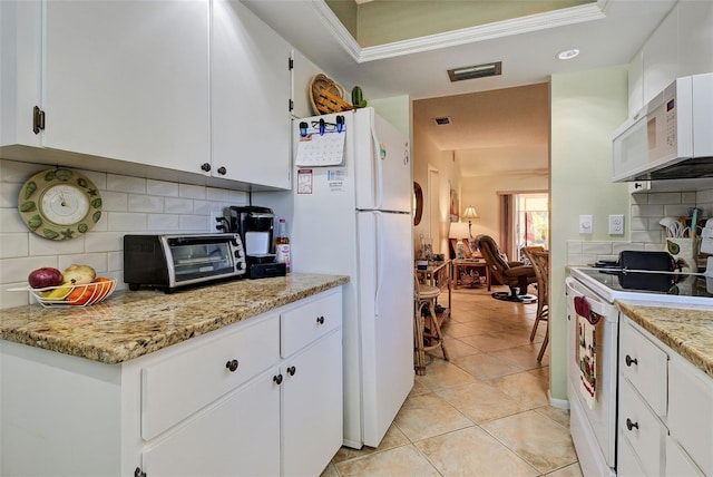 kitchen with white cabinetry, white appliances, light tile patterned flooring, and tasteful backsplash