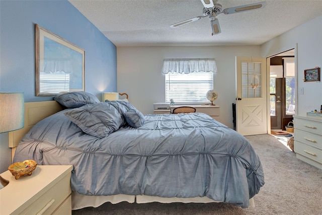 carpeted bedroom featuring a textured ceiling, ceiling fan, and ensuite bathroom