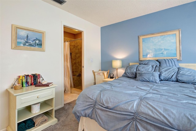 bedroom featuring carpet floors, a textured ceiling, and ensuite bathroom