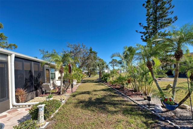 view of yard featuring a sunroom