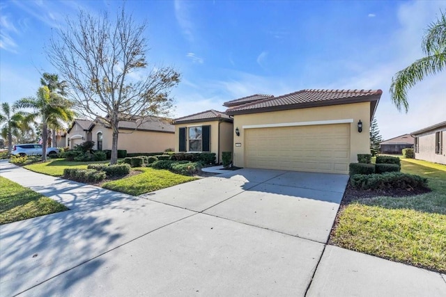 mediterranean / spanish home with a garage and a front lawn