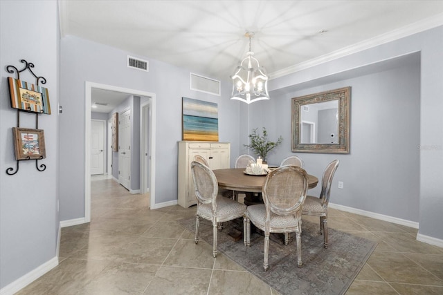 dining area with ornamental molding and an inviting chandelier