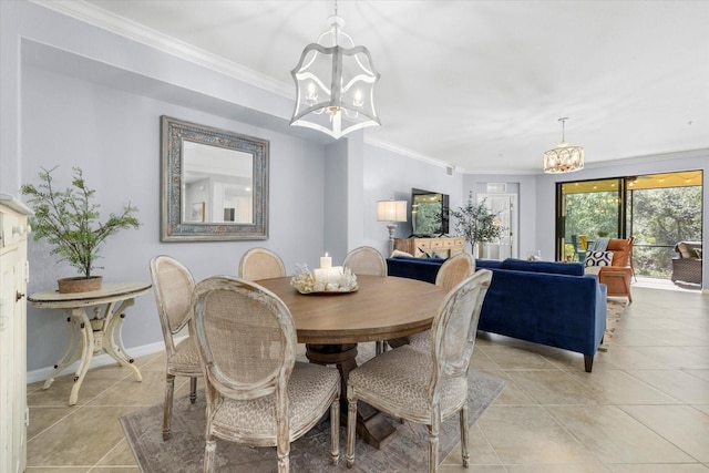 tiled dining room featuring ornamental molding and an inviting chandelier