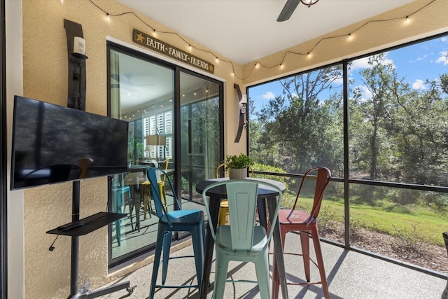 sunroom / solarium with a wealth of natural light and ceiling fan