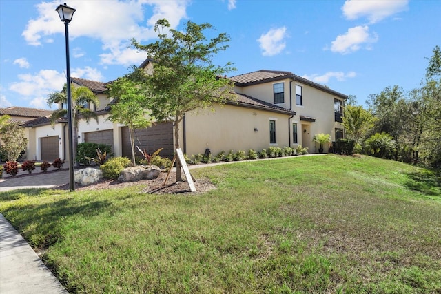 view of side of property featuring a garage and a yard