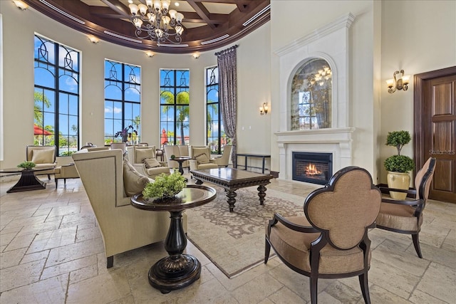 interior space with a towering ceiling, coffered ceiling, crown molding, a notable chandelier, and beamed ceiling