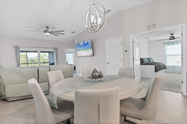 dining room with light tile patterned floors, vaulted ceiling, plenty of natural light, and a notable chandelier