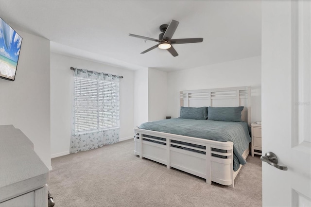 bedroom with light carpet and ceiling fan