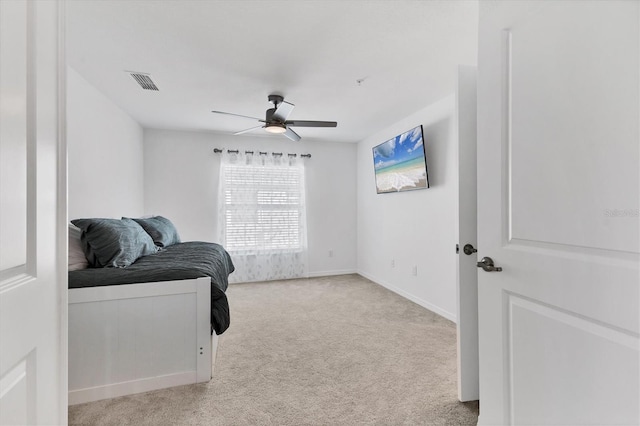 bedroom with ceiling fan and light carpet