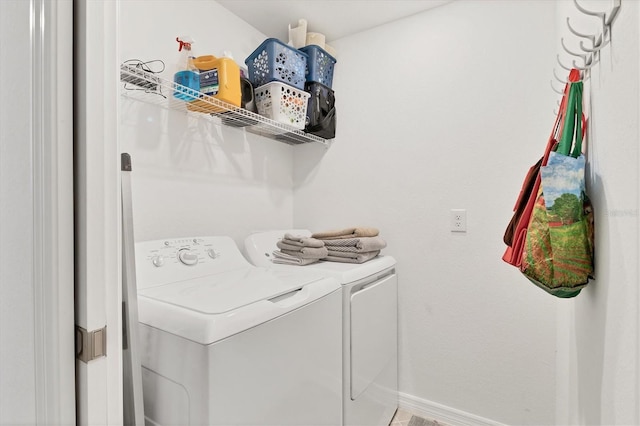 clothes washing area with washer and clothes dryer