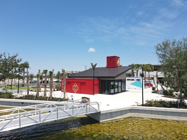 back of house featuring a water view