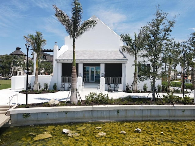 rear view of property with covered porch