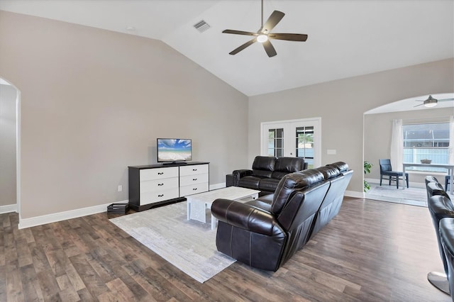 living room featuring lofted ceiling, ceiling fan, and dark wood-type flooring