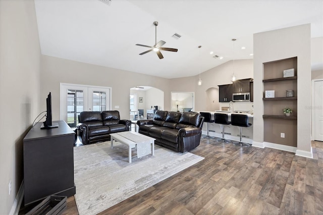 living room with french doors, ceiling fan, hardwood / wood-style floors, and lofted ceiling