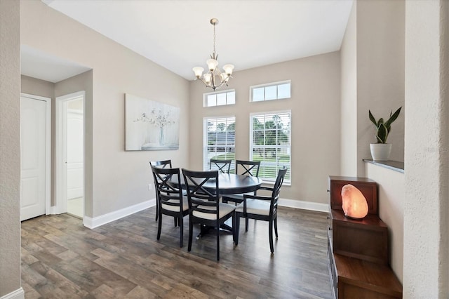 dining area featuring dark hardwood / wood-style floors and a notable chandelier