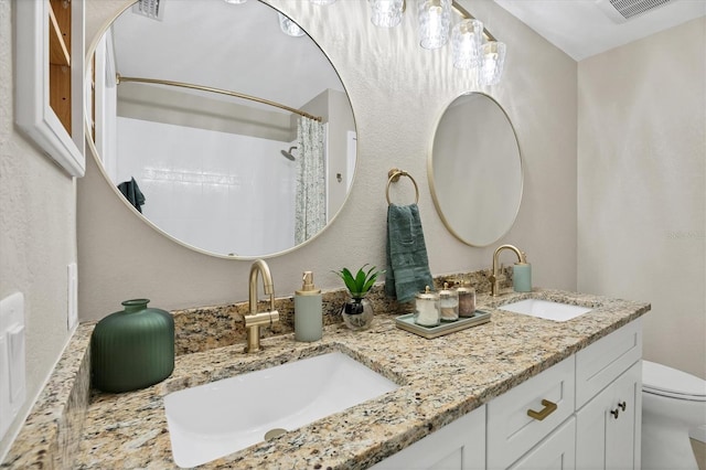 bathroom featuring walk in shower, vanity, and toilet