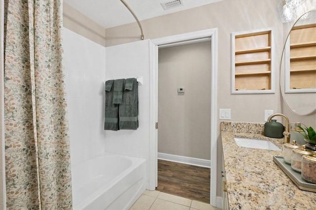 bathroom featuring tile patterned flooring, vanity, and shower / bath combo