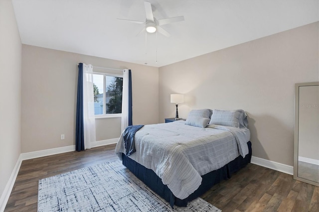 bedroom with ceiling fan and dark hardwood / wood-style floors