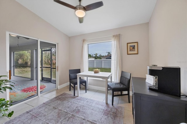 dining area with ceiling fan, lofted ceiling, and light tile patterned flooring