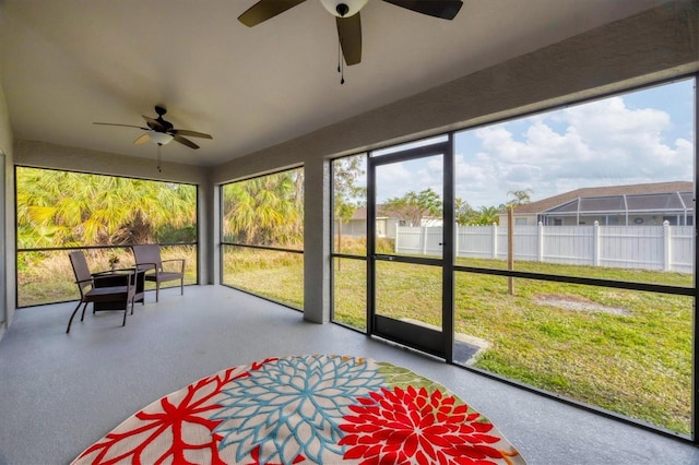 unfurnished sunroom with ceiling fan