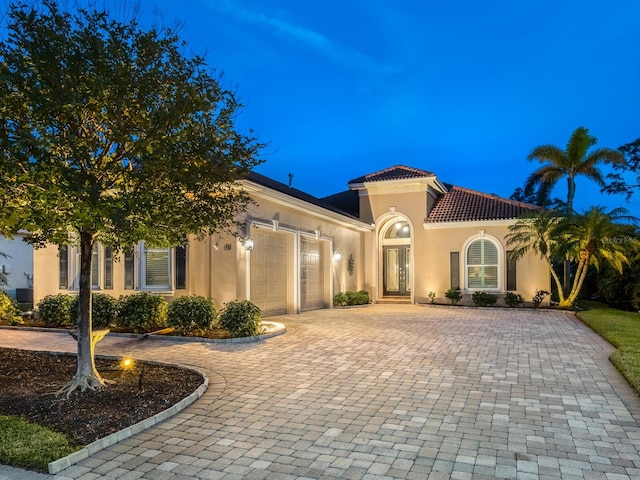 mediterranean / spanish-style house with a garage